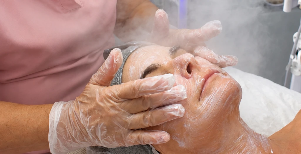 Numun esthetician performing a facial treatment